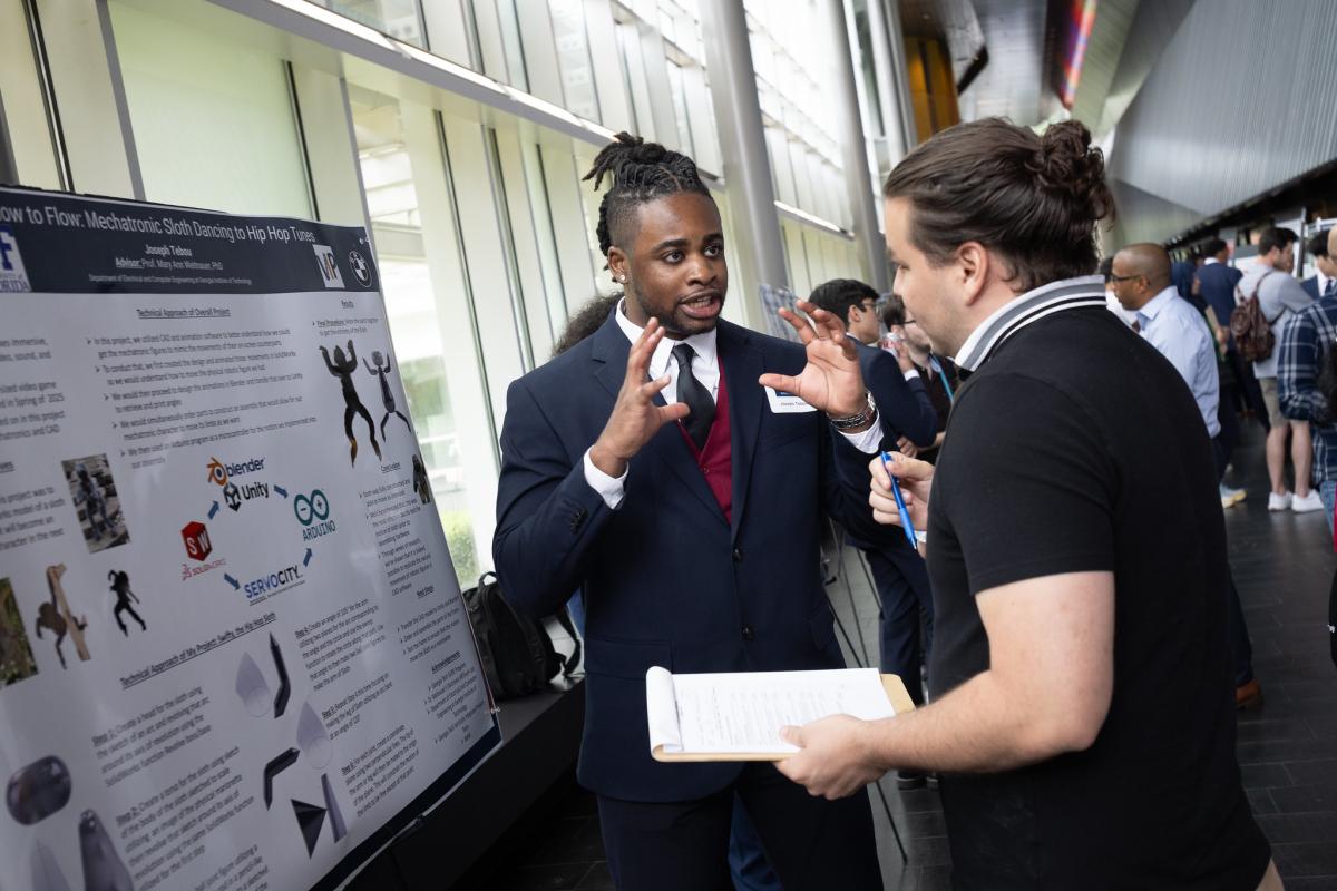 student explaining chart information at SURE event