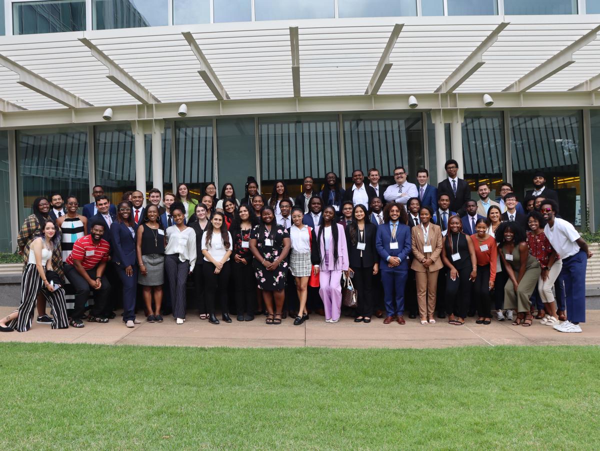 A large SURE group of students posing outside a building. 