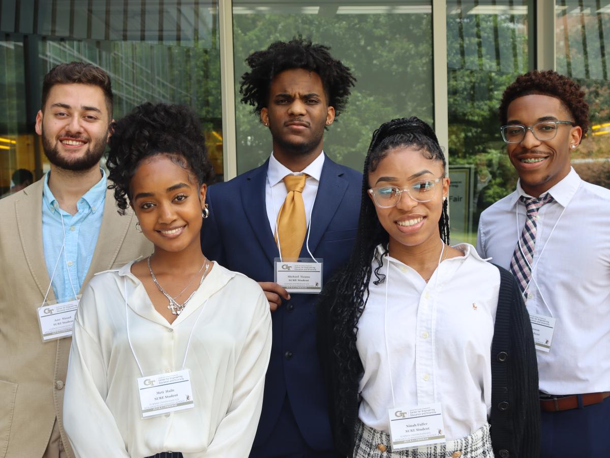 Five students standing together for a photo.