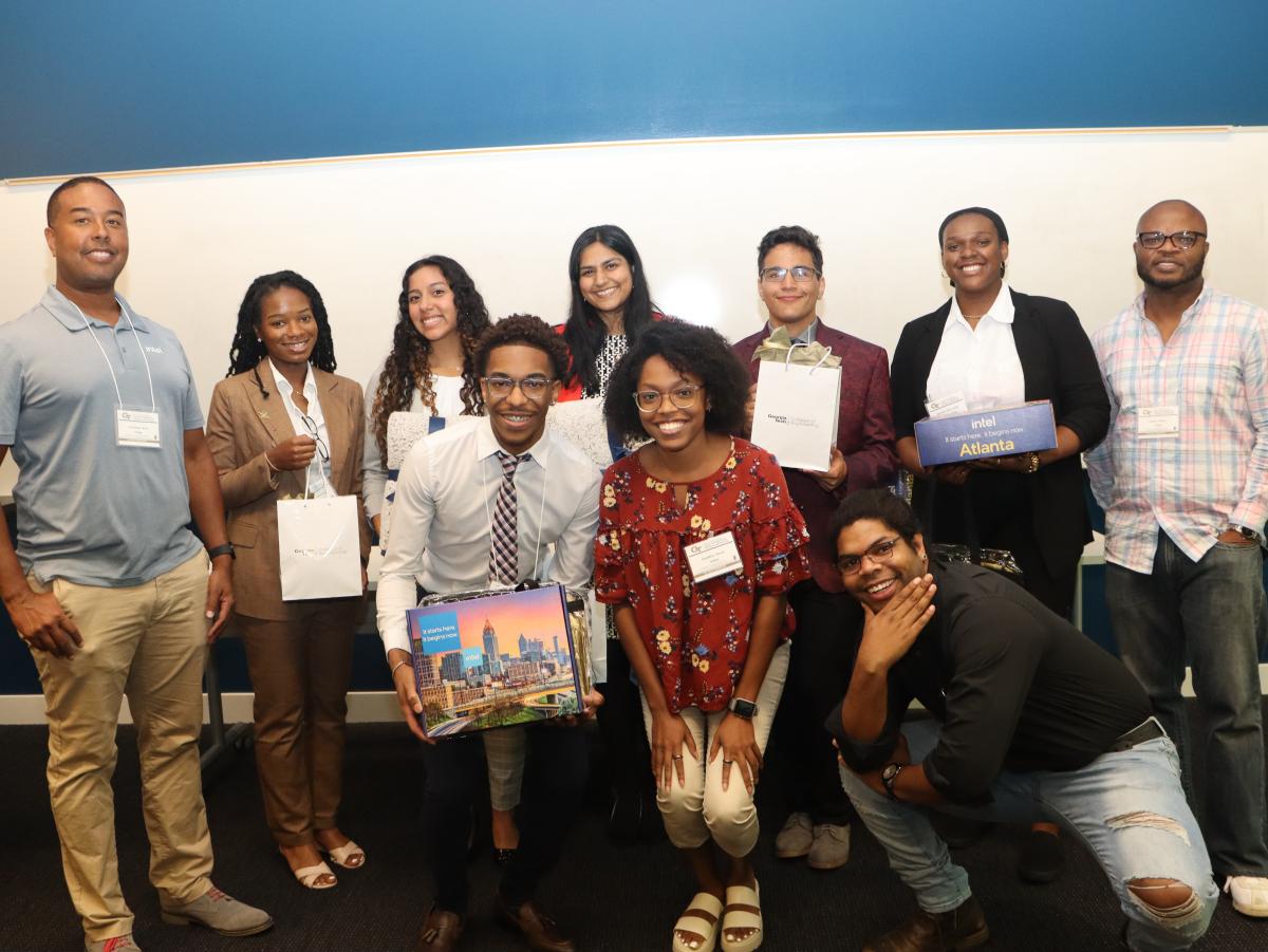 Students standing in front of a wall posing for a group photo.