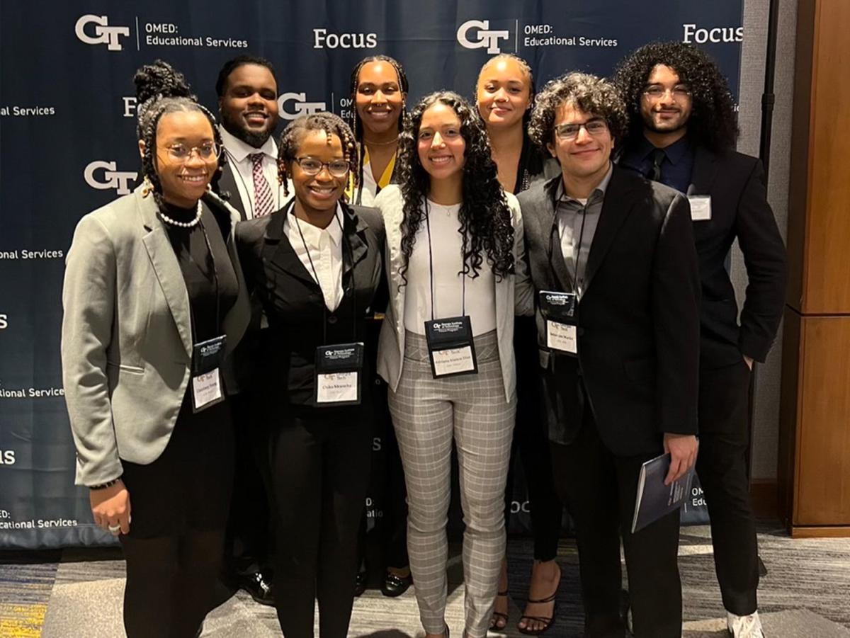 group of students in front of GT backdrop